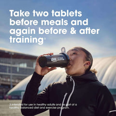 Athlete drinking from Optimum Nutrition shaker bottle outdoors with dosing instructions text Optimum Nutrition Amino 2222 tablets