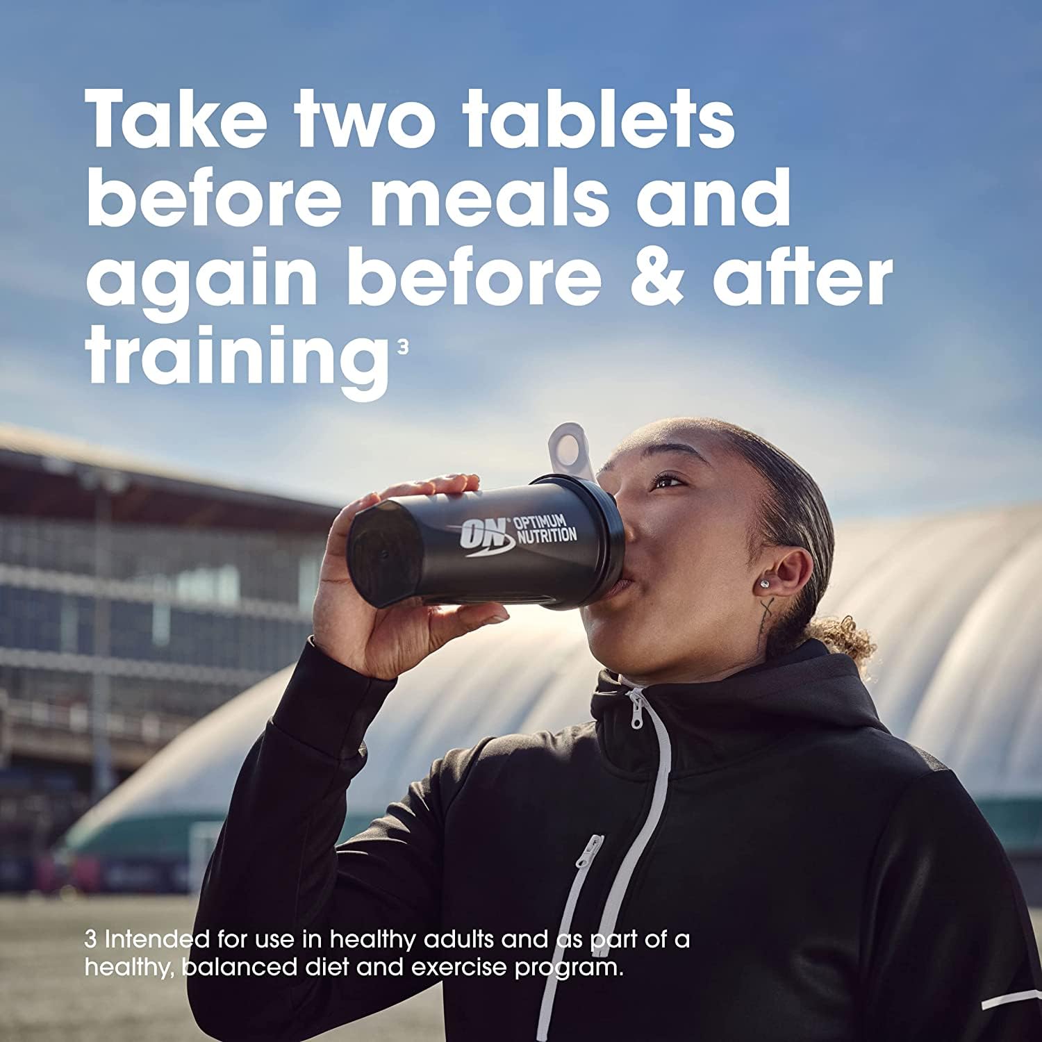 Athlete drinking from Optimum Nutrition shaker bottle outdoors with dosing instructions text Optimum Nutrition Amino 2222 tablets