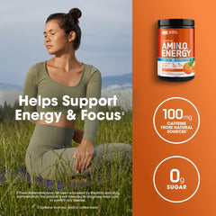 Optimum Nutrition pre workout Amino Energy tub with 100 mg caffeine and 0g sugar beside woman meditating outdoors