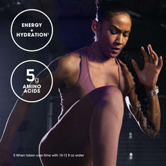 Woman doing high knee exercise wearing mauve workout set with Optimum Nutrition pre workout labels for energy and 5g amino acids