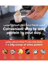 Whey protein powder tub with scoopful of powder ready to add