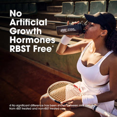 Tennis player drinking from Optimum Nutrition shaker on stadium bleachers with racket whey protein powder UAE