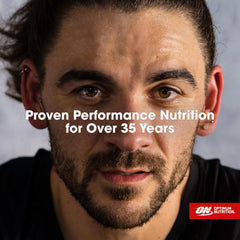 Close up sweaty male athlete face with Optimum Nutrition logo and overlay text promoting whey protein powder UAE