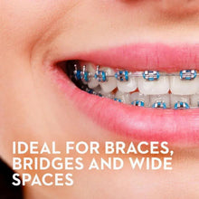 Dental floss strand threaded between teeth with braces and wide spacing
