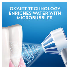 Oral-B Aquacare water flosser demonstrating oxyjet microbubble spray cleaning between teeth