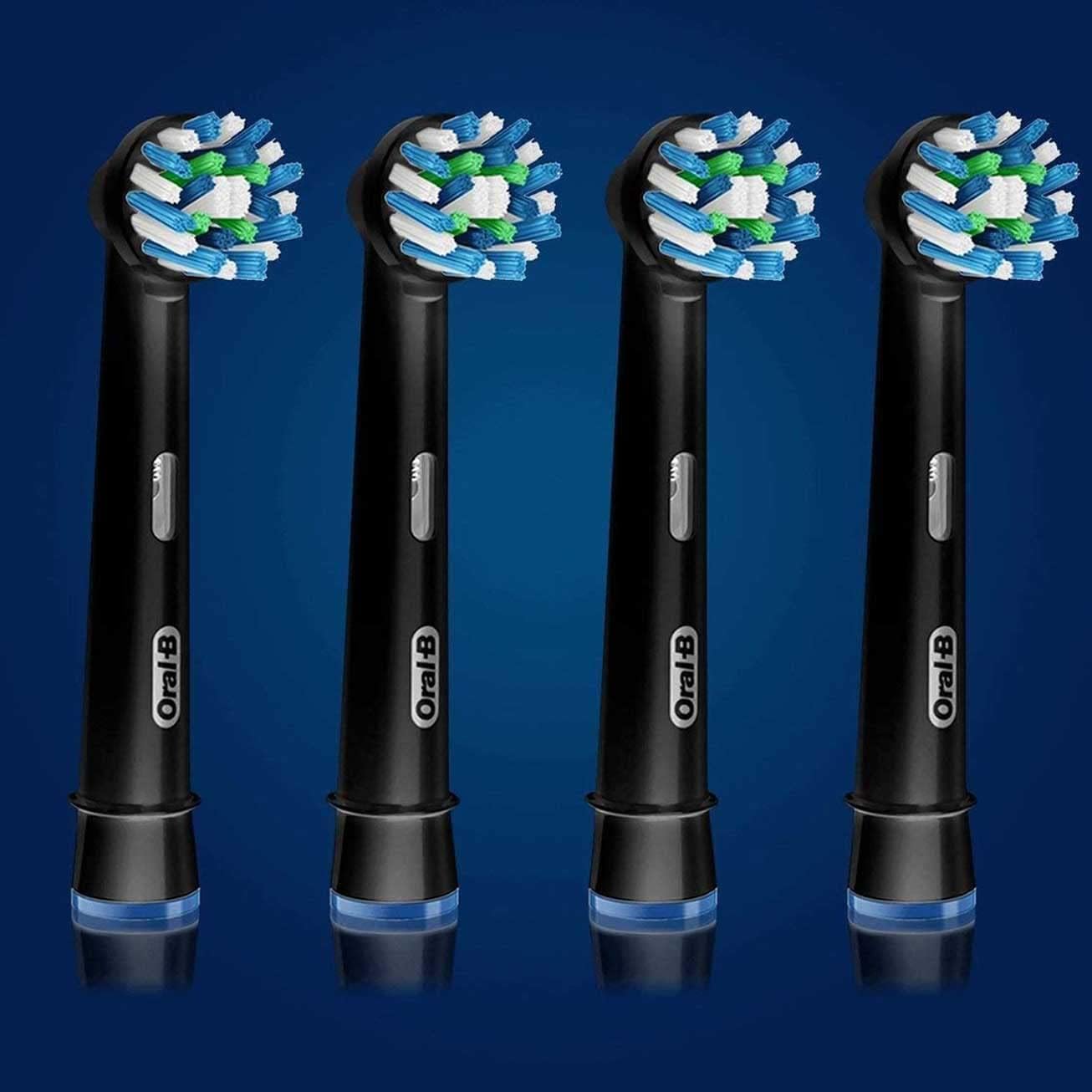 Four black Oral-B brush heads with round blue white green bristles on blue background Oral-B Crossaction replacement heads