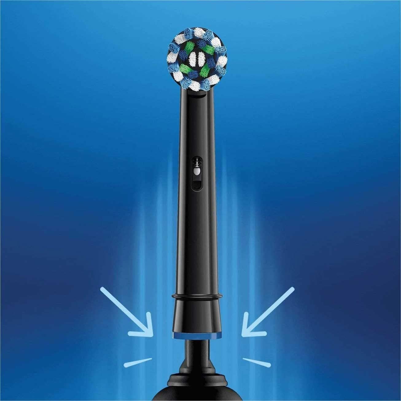Oral-B Crossaction replacement heads on black electric toothbrush with round blue green bristles and arrows indicating attachment