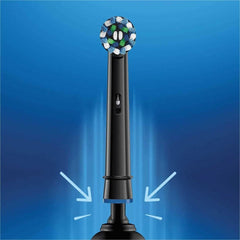 Oral-B Crossaction replacement heads on black electric toothbrush with round blue green bristles and arrows indicating attachment