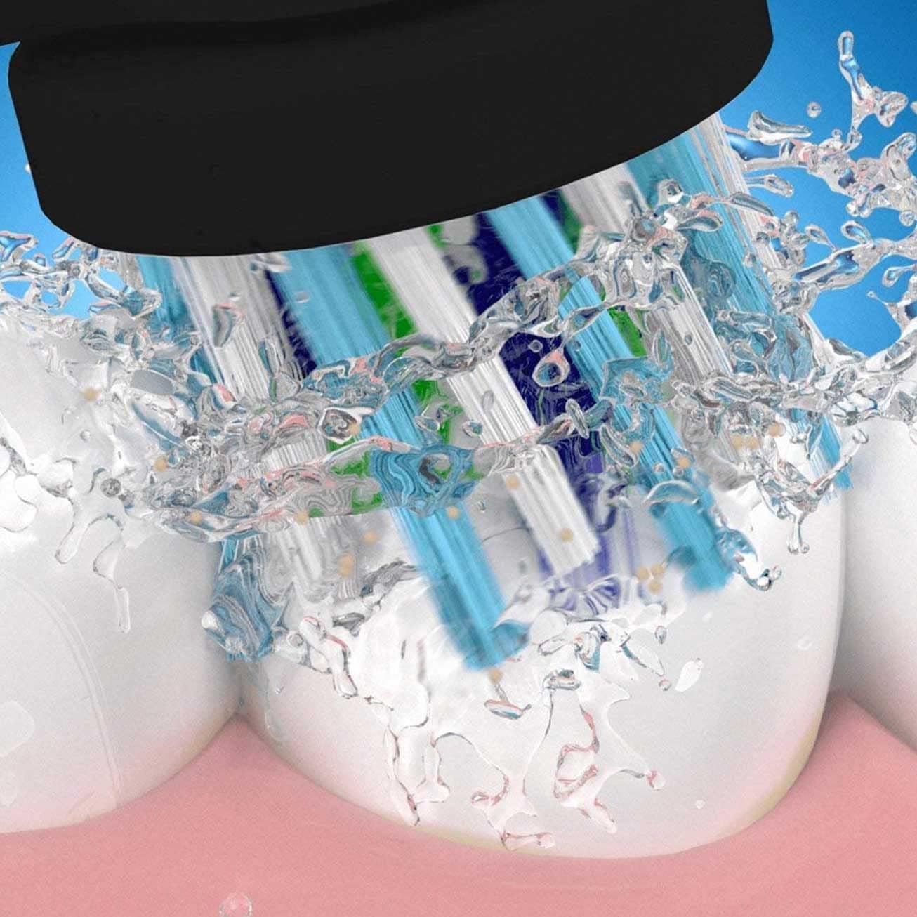 Oral-B Crossaction replacement heads on electric toothbrush cleaning teeth with water splashes and blue bristles