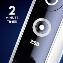 Electric toothbrush handle display showing 2 minute timer and circular control dial
