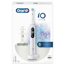 Electric toothbrush shown in retail packaging with white handle and black control panel