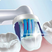 Electric toothbrush brush head cleaning front teeth, with blue bristle tufts