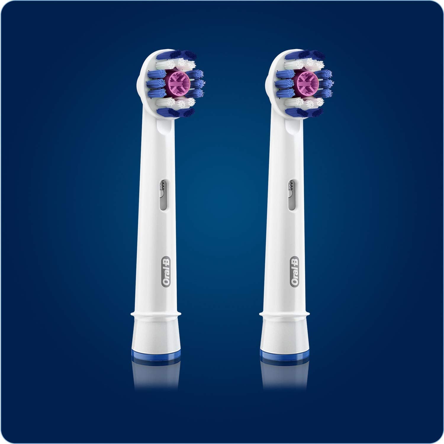 Two Oral-B 3D White replacement brush heads with round blue purple bristles on white stems against blue background