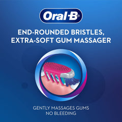 Oral-B CrissCross toothbrush for adults with end rounded bristles and extra soft gum massager on blue background