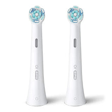 Two white Oral-B iO Ultimate Clean replacement brush heads with blue bristles