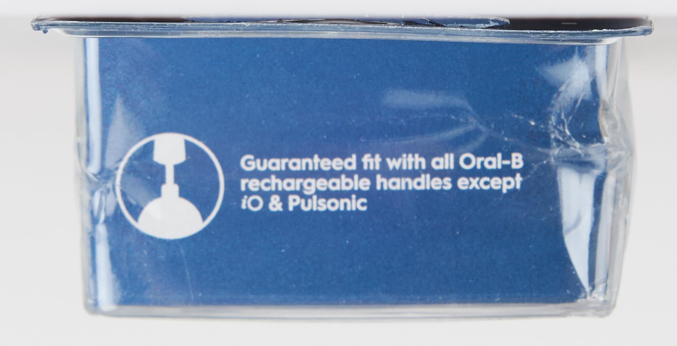Close up of blue Oral-B packaging showing guaranteed fit compatibility text and Oral-B Pro Sensitive Clean toothbrush heads.