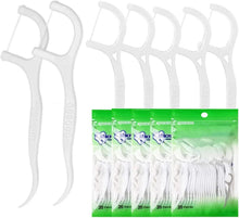 Plastic dental floss picks and green bag packaging, multiple white sticks in view