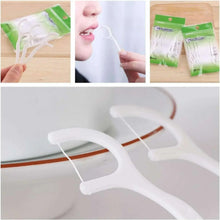 White plastic dental floss pick with looped floss, shown in close-up