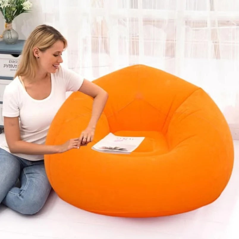 Huitich bright orange beanless chair for outdoor relaxation with a woman sitting on the floor beside it
