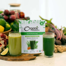 Organic Traditions supergreens pouch with two glasses of green smoothie and produce