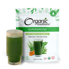 Organic Traditions supergreens powder with turmeric and probiotics pouch with poured green smoothie in two clear glasses