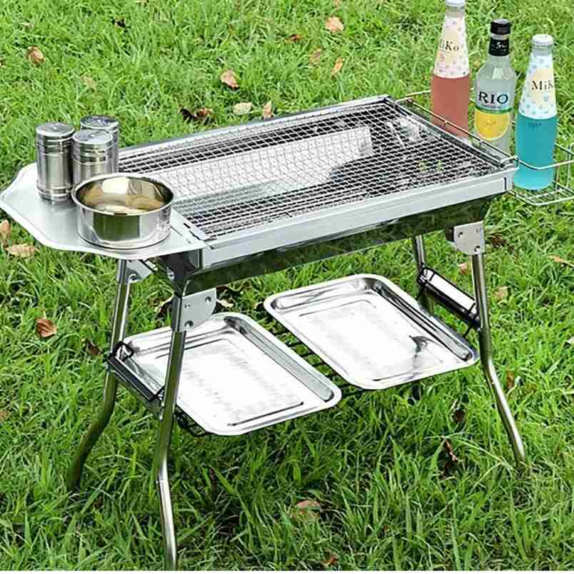 Outdoor barbecue smoker with storage by Huitich featuring stainless steel grill and side trays on grass
