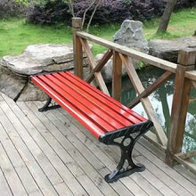 Red slatted bench seat with black metal pedestal base, angled view