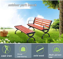 Outdoor bench with red slatted back and seat, black curved armrests and metal base