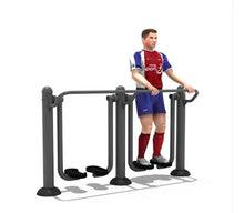 Double air walker fitness machine with central handrails and two curved foot pedals, dark gray