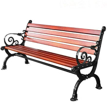 Outdoor bench with red-brown wooden slats and ornate black metal scrollwork frame