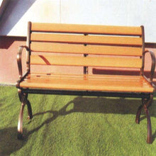Outdoor bench side view with wooden slats, curved black armrests, on grass