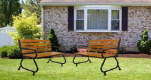 Outdoor bench with two wooden slat backrests, black metal supports, on lawn