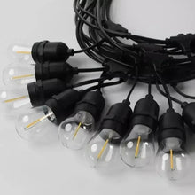 Outdoor string lights with black sockets and clear bulbs, multiple hanging bulbs