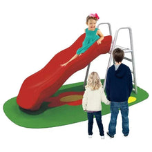 Outdoor wave slide with red slide, green base mat, and kids climbing ladders