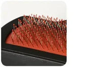 Slicker brush pins on red base cushion, close-up view