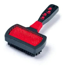 Slicker brush with red cushion pad, black handle, pin bristles