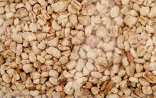 Light beige pellet litter granules, close-up texture