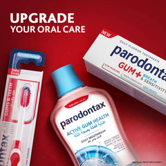 Display of Parodontax toothpaste for gum problems. Mouthwash bottle, toothpaste box and toothbrush on red background