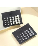 Pearl stud earring set with round crystal studs on separate black display cards