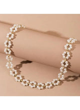 Pearl choker necklace on neck with layered white pearl beaded design