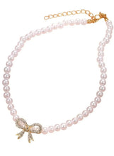 Pearl necklace with bow pendant and rhinestone accents, gold-tone chain clasp
