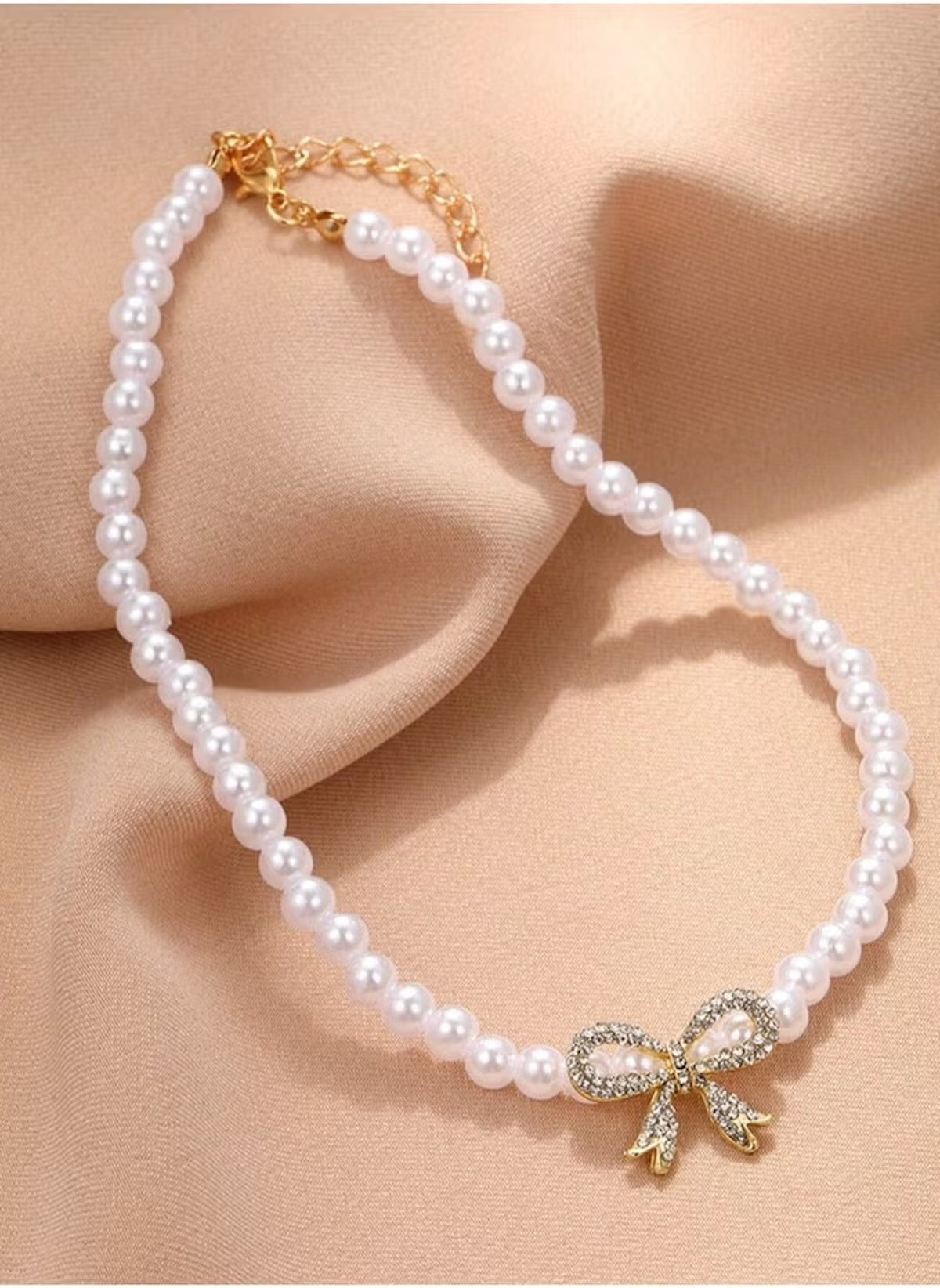 Huitich pearl necklace with bow pendant featuring white pearls and a gold rhinestone bow charm