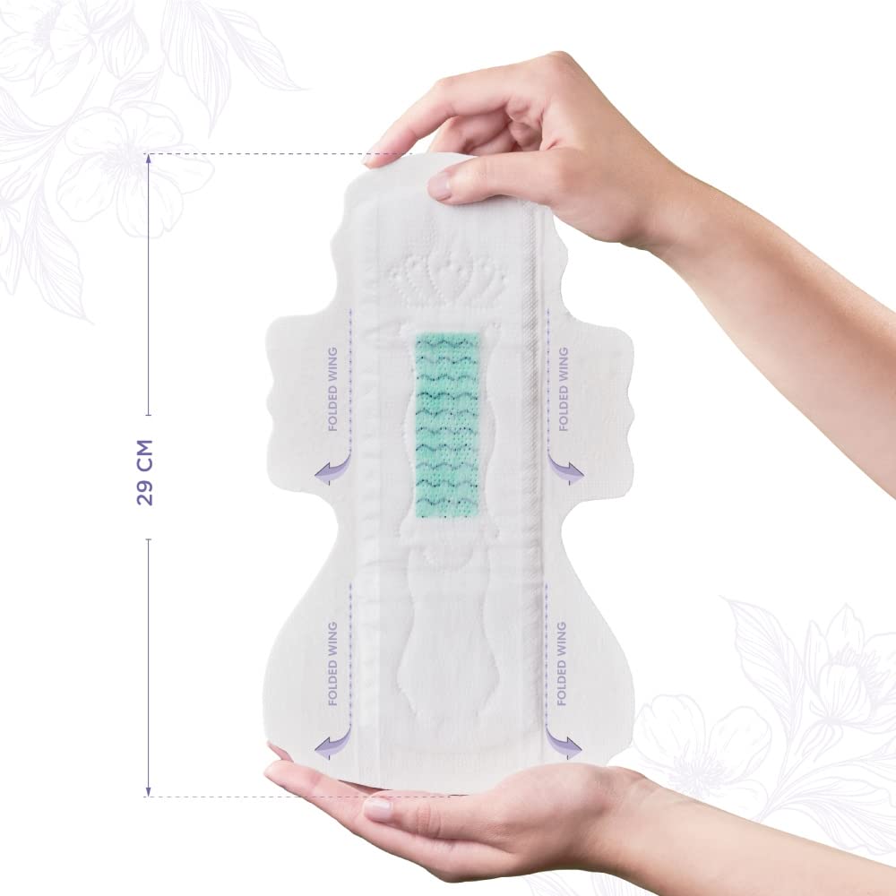PECTIV ultra thin night sanitary pads 29 cm long with wings green absorbent core held in hands
