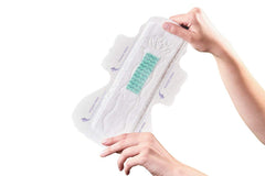PECTIV ultra thin night sanitary pads held open showing wings and green absorbent core for overnight protection