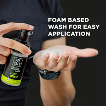 Foam-based intimate wash bottle with black pump dispensing into open palm