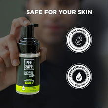 Natural intimate wash for men bottle with pump held in hand, green label accents
