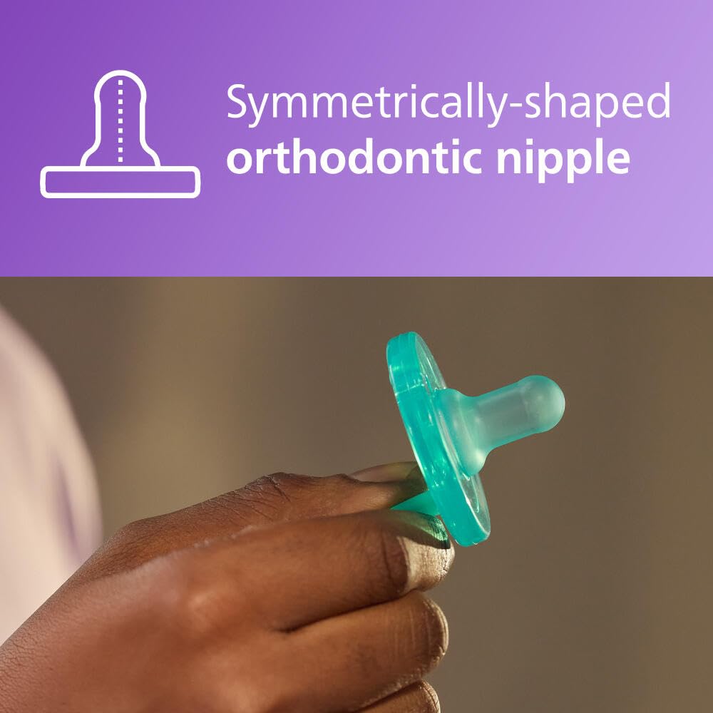Hand holding teal Philips Avent Soothie pacifier 0-3 months with symmetrical orthodontic nipple design
