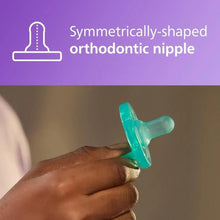 Green Philips Avent Soothie orthodontic nipple pacifier held in hand