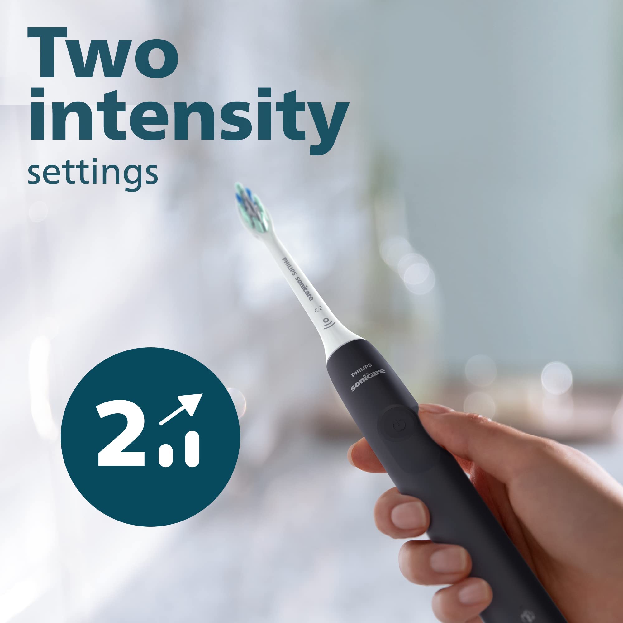 Philips Sonicare 4100 electric toothbrush UAE black handle held in hand showing two intensity settings