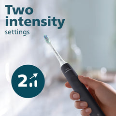 Philips Sonicare 4100 electric toothbrush UAE black handle held in hand showing two intensity settings